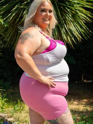 Middle-aged blonde woman displays her massive ass after washing her car