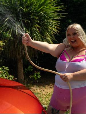 Middle-aged blonde woman displays her massive ass after washing her car Porn Pics english 06