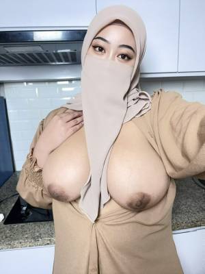 Chubby Asian girl covers her face with a hijab while exposing her big tits Porn Pics english 17